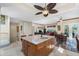 Open concept featuring a kitchen with wood cabinets, stainless steel appliances, and a center island with seating at 10300 Tarpon Landings Ter # 4, Placida, FL 33946