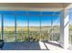 Enjoy the outdoor view from the lanai featuring screening, white support beams and tile flooring at 10300 Tarpon Landings Ter # 4, Placida, FL 33946