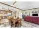 Spacious living area with open kitchen and wood floors, connecting dining and lounge spaces at 10300 Tarpon Landings Ter # 4, Placida, FL 33946