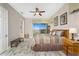 Spacious main bedroom with a ceiling fan, bench and a beautiful view of the surrounding area at 10300 Tarpon Landings Ter # 4, Placida, FL 33946