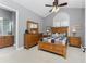 Comfortable bedroom suite featuring wood furniture, ceiling fan, and ensuite bath with double vanity at 10300 Tarpon Landings Ter # 4, Placida, FL 33946
