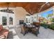Outdoor patio area with comfortable seating, a fireplace, and a glass-top table at 10300 Tarpon Landings Ter # 4, Placida, FL 33946