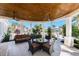 Outdoor patio area with comfortable seating, a glass-top table, and overhead fans at 10300 Tarpon Landings Ter # 4, Placida, FL 33946