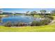 Scenic pond with a fountain, surrounded by lush landscaping, creates a serene community atmosphere at 10300 Tarpon Landings Ter # 4, Placida, FL 33946