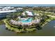 Beautiful aerial view of the community pool surrounded by lush landscaping and waterfront views at 10300 Tarpon Landings Ter # 4, Placida, FL 33946