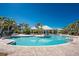 Community pool featuring clear blue water, surrounded by palm trees and brick pavers at 10300 Tarpon Landings Ter # 4, Placida, FL 33946