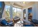 Inviting screened-in porch features cozy seating, a ceiling fan, and scenic outdoor views at 10300 Tarpon Landings Ter # 4, Placida, FL 33946