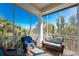 Charming screened-in porch with comfortable seating, providing an airy outdoor experience at 10300 Tarpon Landings Ter # 4, Placida, FL 33946