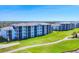 Overhead shot of the condo complex with beautiful landscaping and golf course access, offering stunning views at 12140 Wellen Golf St # 106, Venice, FL 34293