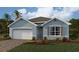 Inviting one-story home with a two-car garage, nicely landscaped front yard, and classic exterior design at 12141 Karney Ave, Port Charlotte, FL 33981