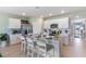 Open-concept kitchen and dining area featuring modern appliances, white cabinetry, and an inviting breakfast bar at 12141 Karney Ave, Port Charlotte, FL 33981