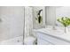 Clean bathroom with a shower-tub combo, contemporary finishes, and a well-lit vanity for a modern touch at 12149 Karney Ave, Port Charlotte, FL 33981