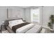 Bedroom featuring a queen bed, neutral decor, large windows, and a stylish bench for a relaxing ambiance at 12149 Karney Ave, Port Charlotte, FL 33981