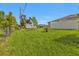 Wide backyard features lush grass, shed, pool cage in the background, and a privacy fence at 1353 Newton St, Port Charlotte, FL 33952