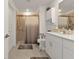 Accessible bathroom with white cabinets, grab bars, and walk in shower with a curtain at 1353 Newton St, Port Charlotte, FL 33952