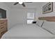 Bedroom with a wood-frame bed, soft gray comforter, and a window with blinds for natural light at 1353 Newton St, Port Charlotte, FL 33952