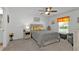 Well-lit bedroom features a queen-size bed, neutral color palette, and natural light at 1353 Newton St, Port Charlotte, FL 33952