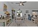 Bright dining area features a round table, cushioned chairs, bar and sliding glass door to the backyard at 1353 Newton St, Port Charlotte, FL 33952