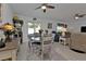 Bright dining area features a round table, cushioned chairs, bar and sliding glass door to the backyard at 1353 Newton St, Port Charlotte, FL 33952