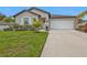 Well maintained house with a lush lawn and tropical plants at 1353 Newton St, Port Charlotte, FL 33952