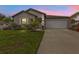 Charming home with a well-kept lawn and tropical landscaping at sunset at 1353 Newton St, Port Charlotte, FL 33952