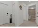 Hallway with white door, tile flooring, neutral walls, and door to the bathroom at 1353 Newton St, Port Charlotte, FL 33952