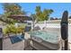 Outdoor hot tub on a patio, shaded by a large umbrella with chairs nearby at 1353 Newton St, Port Charlotte, FL 33952