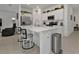 Bright kitchen with white cabinets, stainless steel appliances, a large island, and stylish bar stools at 1353 Newton St, Port Charlotte, FL 33952