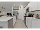Contemporary kitchen with stainless steel appliances, white cabinetry, and a spacious countertop at 1353 Newton St, Port Charlotte, FL 33952