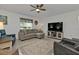 Comfortable living space features tile floors, a couch, recliners and a television at 1353 Newton St, Port Charlotte, FL 33952
