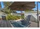 Shaded patio with seating and a hot tub, surrounded by a white fence at 1353 Newton St, Port Charlotte, FL 33952