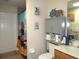 Functional bathroom with a toilet, sink vanity, cabinet, and a shower with a colorful curtain at 1500 Westover St, Port Charlotte, FL 33953