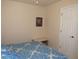 Cozy bedroom with neutral walls, a comfortable bed with blue comforter and a functional white closet door at 1500 Westover St, Port Charlotte, FL 33953