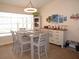 Dining area with a modern chandelier, coastal decor, and bright natural light at 1500 Westover St, Port Charlotte, FL 33953
