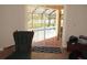 Cozy screened lanai overlooks a sparkling pool and landscaped backyard through sliding glass door at 1500 Westover St, Port Charlotte, FL 33953