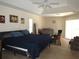 Spacious main bedroom with a large bed, ceiling fan, tile flooring and ample natural light at 1500 Westover St, Port Charlotte, FL 33953