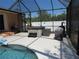 Screened-in patio with a hot tub, barbecue, and covered grill area adjacent to the inviting pool at 1500 Westover St, Port Charlotte, FL 33953