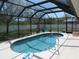 Sparkling screened-in pool with a black frame and a white pool deck, perfect for enjoying sunny days at 1500 Westover St, Port Charlotte, FL 33953