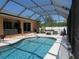 A screened pool area is perfect for relaxing, with a hot tub, grill, and outdoor lounging area at 1500 Westover St, Port Charlotte, FL 33953
