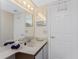 Clean, bright bathroom with a vanity and well-lit mirror at 1601 Park Beach Cir # 114/4, Punta Gorda, FL 33950