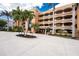 Beautiful exterior of condo building with tropical landscaping at 1601 Park Beach Cir # 114/4, Punta Gorda, FL 33950