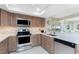 Well-lit kitchen features stainless appliances, bright counters, and tile backsplash at 1601 Park Beach Cir # 114/4, Punta Gorda, FL 33950