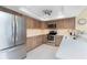 Modern kitchen featuring stainless steel appliances, bright countertops, and ample storage space at 1601 Park Beach Cir # 114/4, Punta Gorda, FL 33950