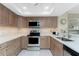 Bright kitchen features modern appliances, light countertops, and tile backsplash at 1601 Park Beach Cir # 114/4, Punta Gorda, FL 33950
