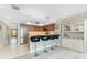 Kitchen bar featuring black stools and stainless steel appliances and bright tile floors at 1601 Park Beach Cir # 114/4, Punta Gorda, FL 33950