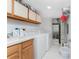 Organized laundry room with white appliances, storage cabinets, and a sink at 1601 Park Beach Cir # 114/4, Punta Gorda, FL 33950