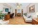 Inviting home office with a desk, bookshelves, a comfortable sofa, and wood floors at 1601 Park Beach Cir # 114/4, Punta Gorda, FL 33950