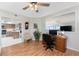 Bright office space features a wooden desk, chair and view to the kitchen through a large opening at 1601 Park Beach Cir # 114/4, Punta Gorda, FL 33950