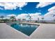 Community pool overlooking the open water with comfortable chaise lounges and dining set at 1601 Park Beach Cir # 114/4, Punta Gorda, FL 33950