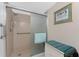 Accessible shower with grab bars, a sliding door, and tasteful decor in a well-lit bathroom at 1601 Park Beach Cir # 114/4, Punta Gorda, FL 33950